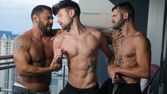 Fine male gets shared by two hunks in superb gay threesome
