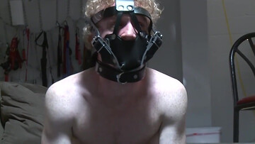 Submisssive man with long hair acts as a pet for his master