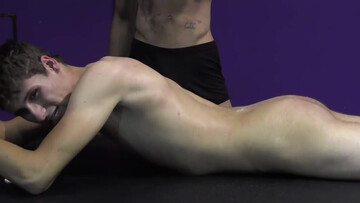 The muscular master pouring wax on the body of the sub