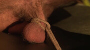 Painful teasing by a dom while he is tied up with a rope