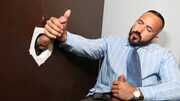 Doominant man plays with a businessman at the glory hole