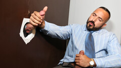 Doominant man plays with a businessman at the glory hole