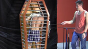 Caged boy is being whipped and seduced through BDSM