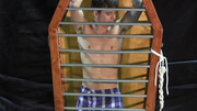 Caged boy is being whipped and seduced through BDSM