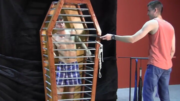 Caged boy is being whipped and seduced through BDSM