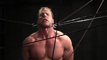 Muscular DILF stands restrained and ready for his punishment