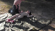 Submissive guy is tied up and blindfolded in the field