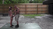 Bald male plays dominant with his boyfriend in a backyard BDSM treat