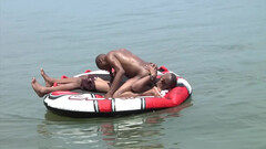 Wet action next to a boat for some horny black dudes