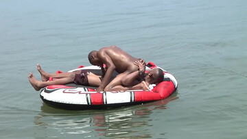 Wet action next to a boat for some horny black dudes