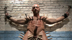 Bald bodybuilder has his entire body covered while bound